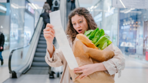 photo of woman looking at grocery receipt